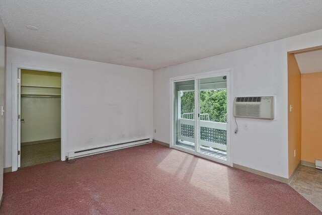 11 Arbor Way Unit C, Holyoke, MA 01040 - unfurnished room with a baseboard radiator, carpet floors, a wall mounted air conditioner, and a textured ceiling