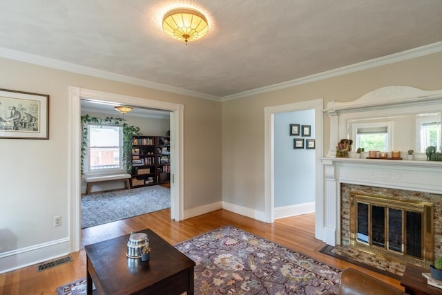 37 Chestnut St, Stoneham, MA 02180 - living room featuring wood finished floors, plenty of natural light, baseboards, ornamental molding, and a fireplace