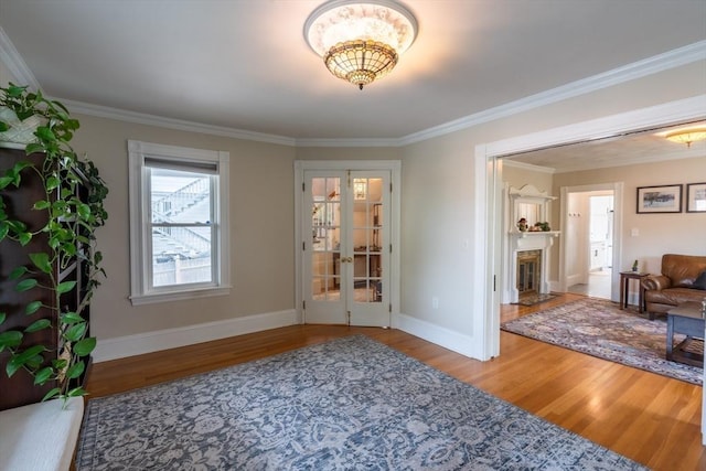 37 Chestnut St, Stoneham, MA 02180 - entryway featuring wood finished floors, crown molding, baseboards, french doors, and a chandelier