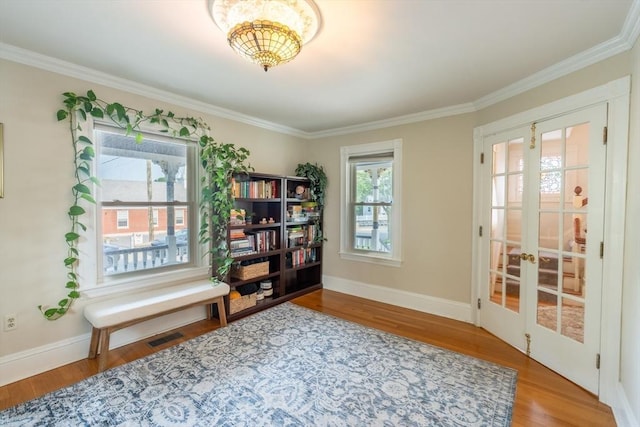 37 Chestnut St, Stoneham, MA 02180 - living area with ornamental molding, wood finished floors, baseboards, and french doors