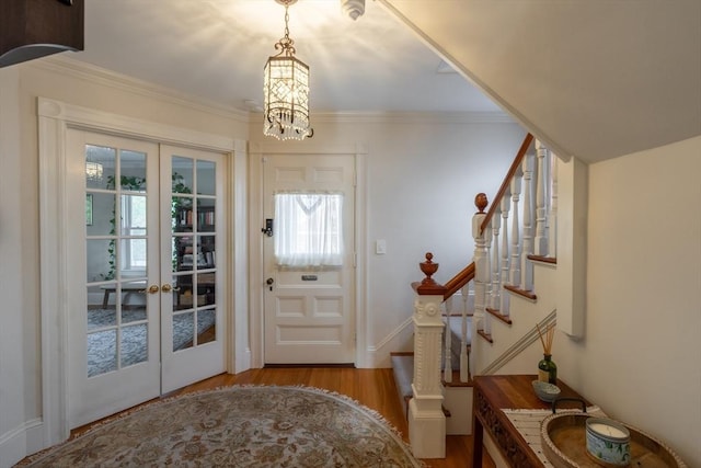 37 Chestnut St, Stoneham, MA 02180 - entryway with french doors, wood finished floors, stairs, plenty of natural light, and ornamental molding