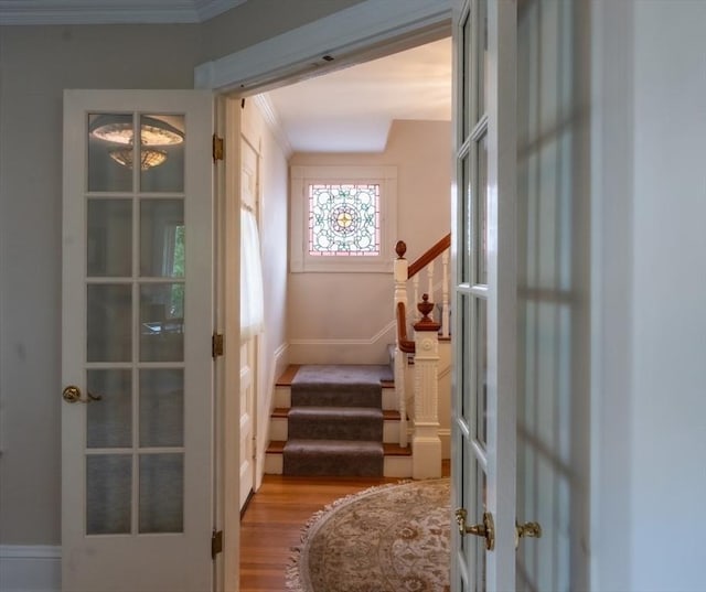 37 Chestnut St, Stoneham, MA 02180 - doorway to outside featuring french doors, wood finished floors, stairway, baseboards, and crown molding