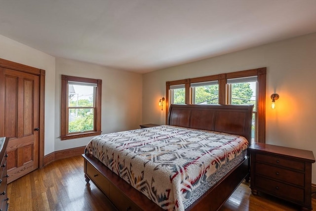 37 Chestnut St, Stoneham, MA 02180 - bedroom featuring wood finished floors, multiple windows, and baseboards