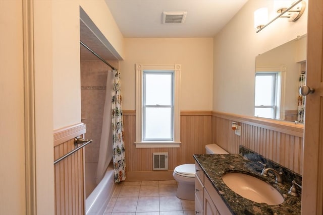 37 Chestnut St, Stoneham, MA 02180 - full bathroom with a wainscoted wall, toilet, healthy amount of natural light, tile patterned floors, and vanity