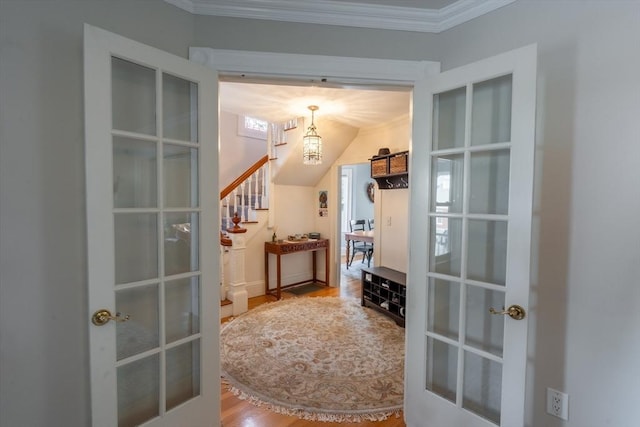 37 Chestnut St, Stoneham, MA 02180 - hall with french doors, stairway, crown molding, a chandelier, and wood finished floors