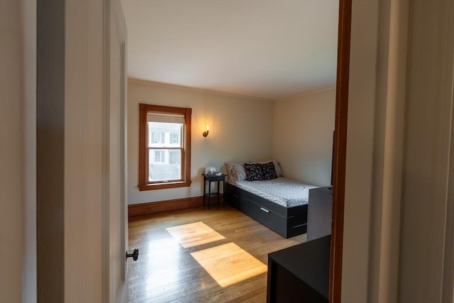 37 Chestnut St, Stoneham, MA 02180 - bedroom with light wood-style flooring, baseboards, and ornamental molding