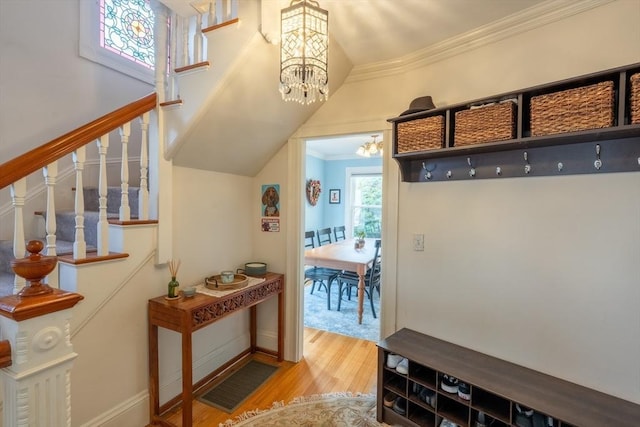 37 Chestnut St, Stoneham, MA 02180 - mudroom with a chandelier, wood finished floors, and ornamental molding