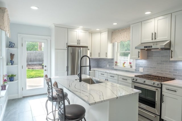 37 Chestnut St, Stoneham, MA 02180 - kitchen with stainless steel appliances, under cabinet range hood, a sink, plenty of natural light, and recessed lighting