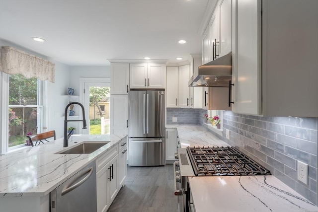 37 Chestnut St, Stoneham, MA 02180 - kitchen featuring stainless steel appliances, ventilation hood, a sink, white cabinets, and recessed lighting