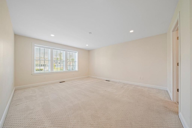 unfurnished room featuring light colored carpet, recessed lighting, and baseboards