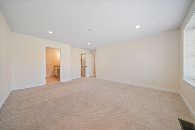 unfurnished room with baseboards, visible vents, recessed lighting, and light colored carpet