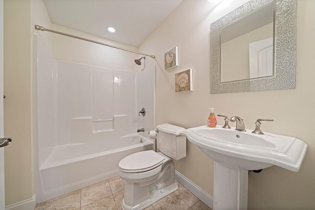 bathroom featuring baseboards, toilet, and shower / washtub combination