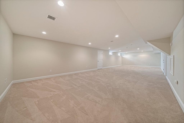 finished basement with baseboards, light colored carpet, recessed lighting, and visible vents