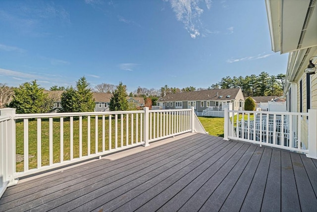 deck featuring a residential view and a yard
