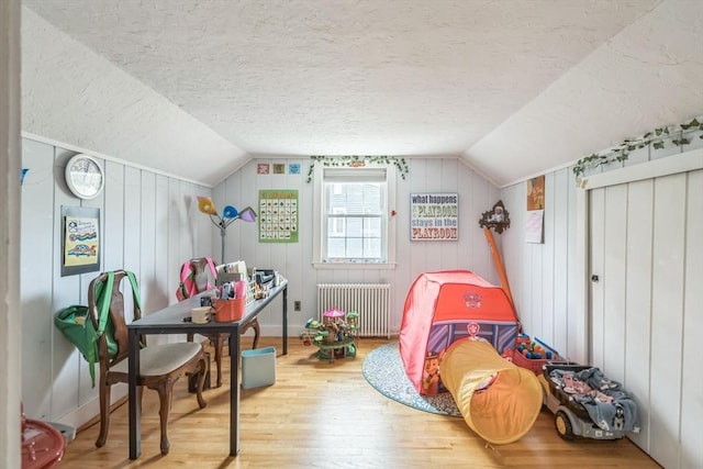 521 Pleasant St, Weymouth, MA 02190 - bedroom with radiator heating unit, hardwood / wood-style floors, lofted ceiling, and a textured ceiling