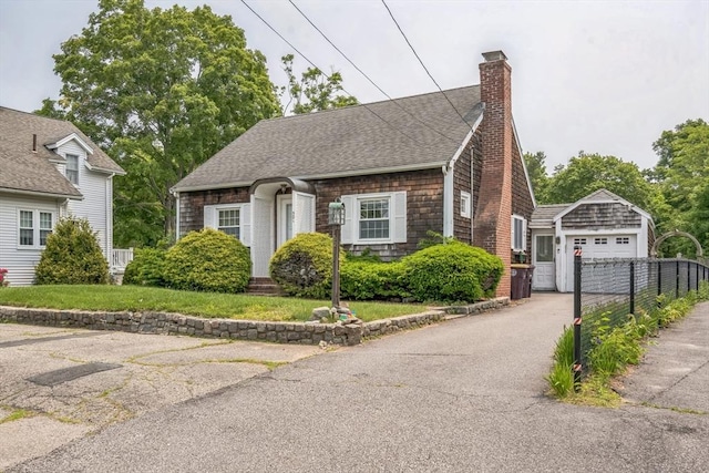 521 Pleasant St, Weymouth, MA 02190 - view of front of property with an outbuilding, a detached garage, a chimney, driveway, and roof with shingles
