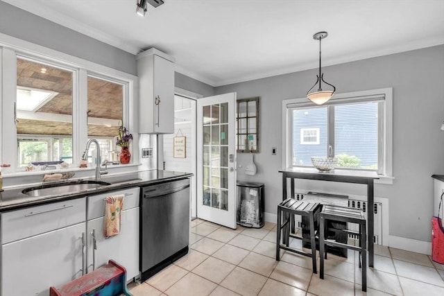521 Pleasant St, Weymouth, MA 02190 - kitchen featuring dishwashing machine, dark countertops, light tile patterned floors, ornamental molding, and pendant lighting