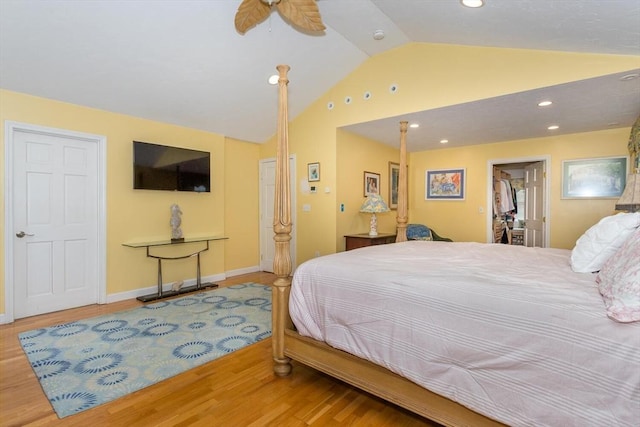 bedroom with lofted ceiling, wood finished floors, recessed lighting, and baseboards