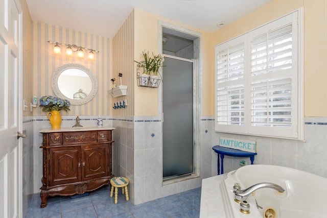 full bathroom with tile patterned floors, a shower stall, wallpapered walls, and tile walls