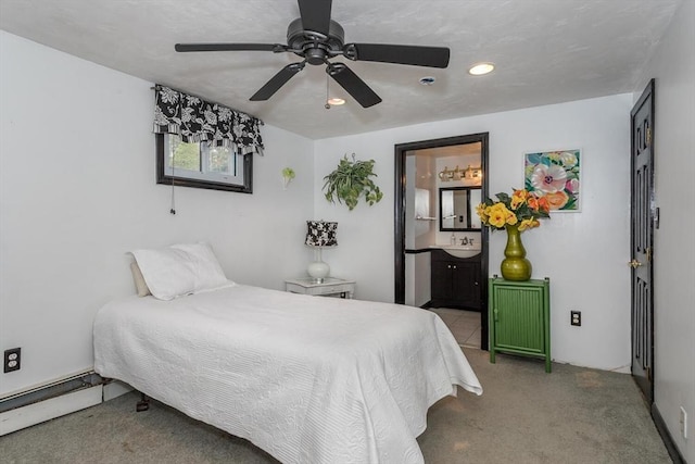 carpeted bedroom with baseboard heating, recessed lighting, ceiling fan, and connected bathroom