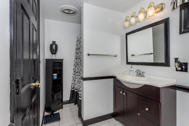 bathroom with visible vents, vanity, and tile patterned flooring