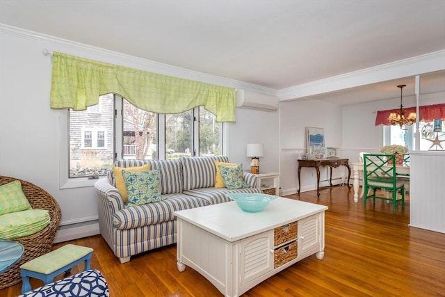 living area featuring a wall mounted AC, wood finished floors, crown molding, and a baseboard radiator