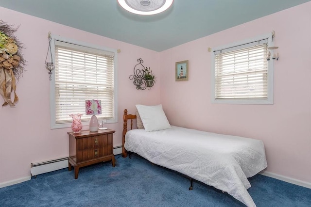 carpeted bedroom with a baseboard heating unit, baseboard heating, and baseboards