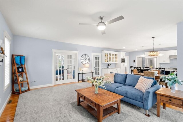 15 Day Lily Ln, Walpole, MA 02081 - living room with ceiling fan, baseboards, light wood finished floors, and french doors