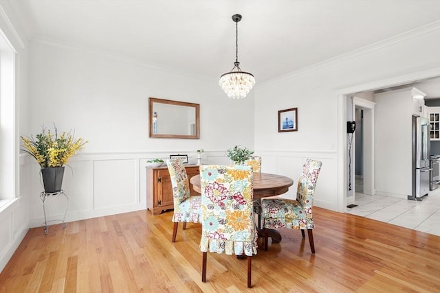 15 Day Lily Ln, Walpole, MA 02081 - dining room featuring a decorative wall, a chandelier, light wood-type flooring, ornamental molding, and a wainscoted wall