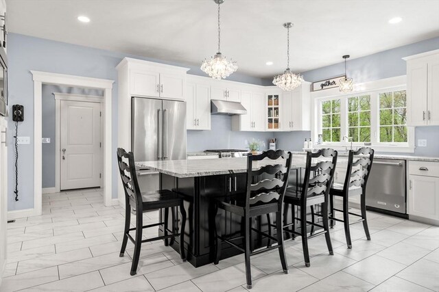 15 Day Lily Ln, Walpole, MA 02081 - kitchen with stainless steel appliances, a chandelier, under cabinet range hood, white cabinets, and recessed lighting
