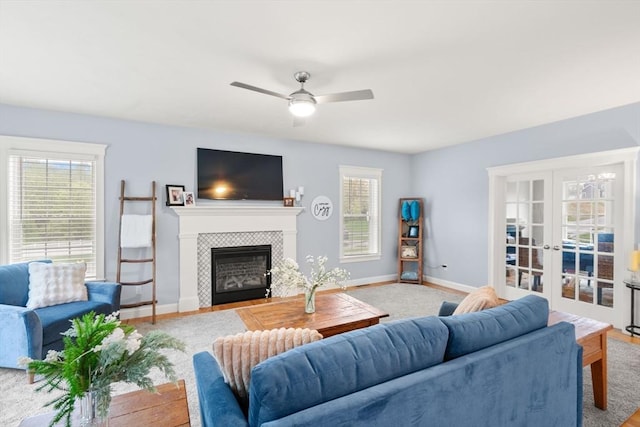 15 Day Lily Ln, Walpole, MA 02081 - living area featuring a tiled fireplace, ceiling fan, baseboards, and french doors
