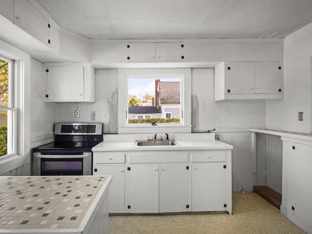 8 Rock Harbor Rd, Orleans, MA 02653 - kitchen featuring stainless steel electric stove, a sink, white cabinetry, light countertops, and plenty of natural light