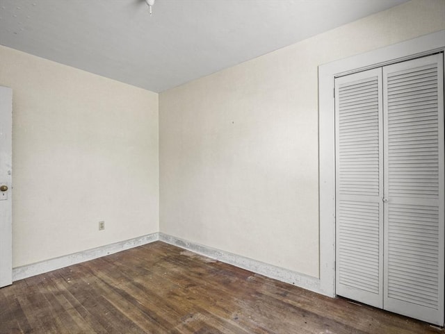 8 Rock Harbor Rd, Orleans, MA 02653 - unfurnished bedroom featuring dark wood-type flooring, a closet, and baseboards