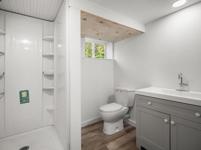 8 Rock Harbor Rd, Orleans, MA 02653 - bathroom with wood finished floors, a shower stall, toilet, vanity, and baseboards