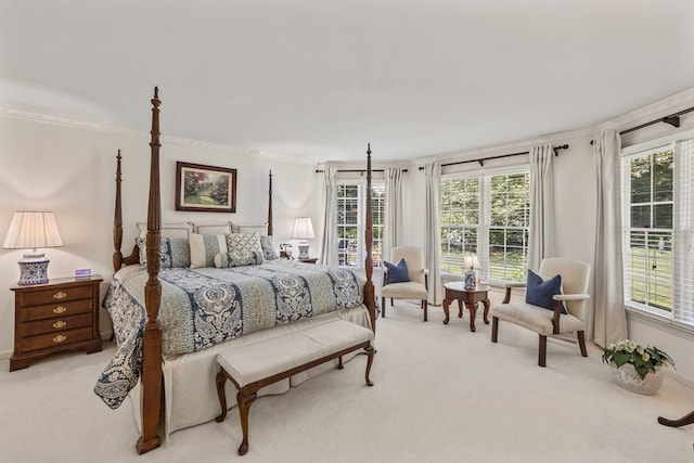 bedroom with light colored carpet, ornamental molding, and multiple windows