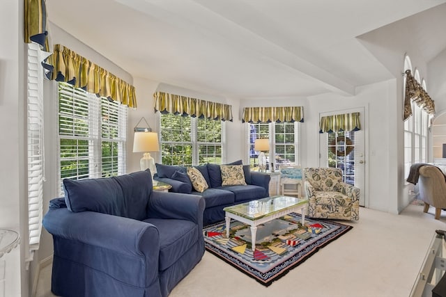 living room with beamed ceiling and carpet