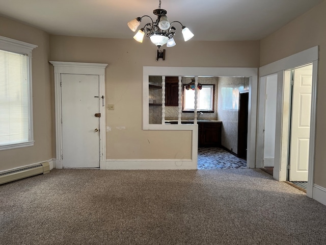 interior space featuring baseboard heating, carpet flooring, and a chandelier