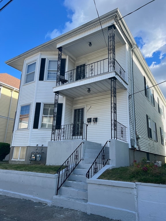 view of front of home with a balcony and covered porch