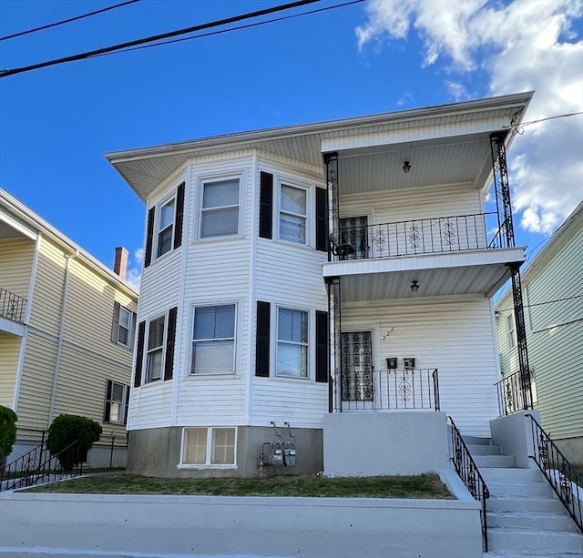 view of front of property with a balcony