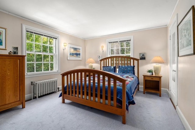 carpeted bedroom with radiator heating unit, ornamental molding, and baseboards