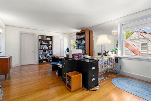 home office featuring light wood-style flooring and baseboards