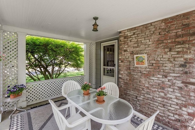sunroom featuring outdoor dining space