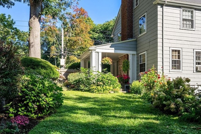 view of side of property with a yard