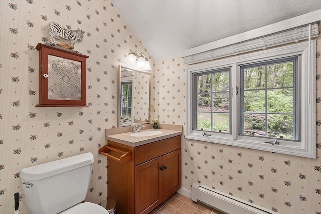31 Spectacle Hill Rd, Bolton, MA 01740 - bathroom with vaulted ceiling, a baseboard heating unit, vanity, toilet, and wallpapered walls