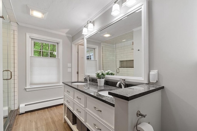 31 Spectacle Hill Rd, Bolton, MA 01740 - full bath with a baseboard heating unit, a stall shower, wood finished floors, double vanity, and crown molding