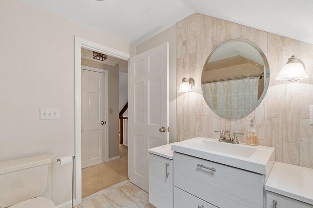 31 Spectacle Hill Rd, Bolton, MA 01740 - bathroom featuring vanity, toilet, lofted ceiling, and marble look tiles
