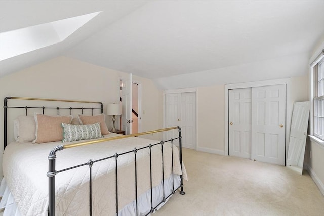 31 Spectacle Hill Rd, Bolton, MA 01740 - bedroom featuring light colored carpet, a skylight, multiple closets, lofted ceiling, and baseboards