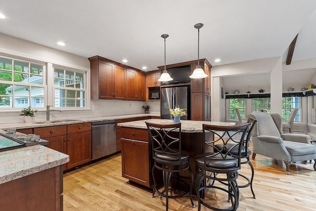 31 Spectacle Hill Rd, Bolton, MA 01740 - kitchen featuring stainless steel appliances, a sink, light wood finished floors, a center island, and decorative backsplash