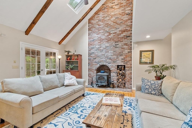 31 Spectacle Hill Rd, Bolton, MA 01740 - living area featuring high vaulted ceiling, french doors, wood finished floors, a skylight, and beamed ceiling