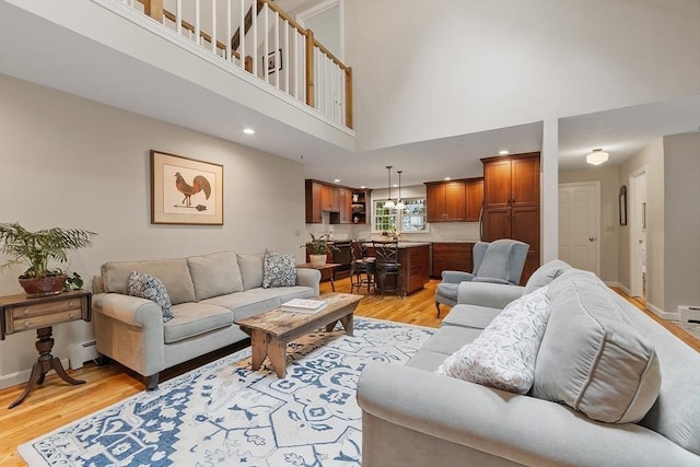 31 Spectacle Hill Rd, Bolton, MA 01740 - living area with light wood-style floors, a baseboard radiator, a towering ceiling, baseboards, and recessed lighting